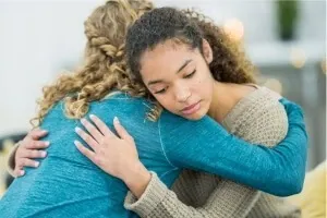 women hugging-Finding Closure After A Divorce